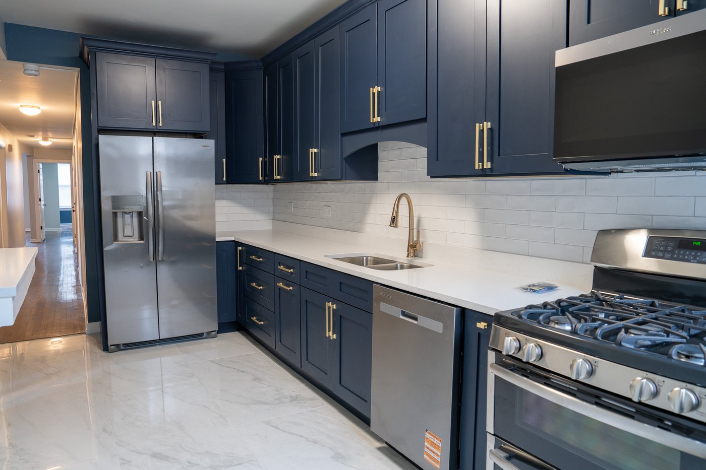 Kitchen with stainless refrigerator and gas range